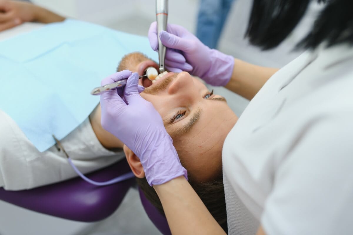 Wypełnienia zęba - dentystka badająca jamę ustną pacjenta